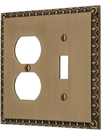 Ovolo Toggle/Duplex Combination Switch Plate in Antique Brass.